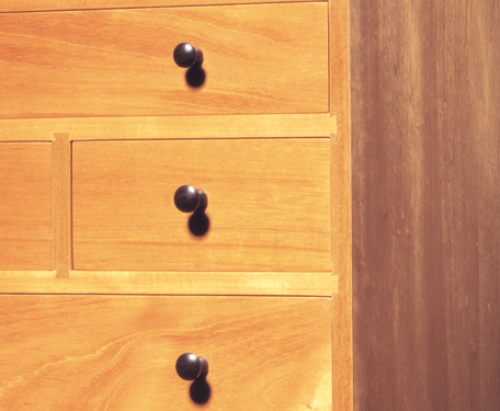 Closeup of Chest of Drawers on Stand in Honduran mahogany, cherry drawer sides and back, and African blackwood handles. 52H x 18W x 15D