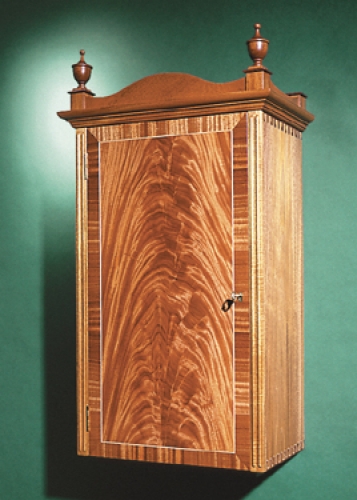 Federal Wall Cabinet in honduran mahogany and crotch mahogany veneer, with maple inlaid Isoloc Mirror Key joinery. 34H x 18W x 11D